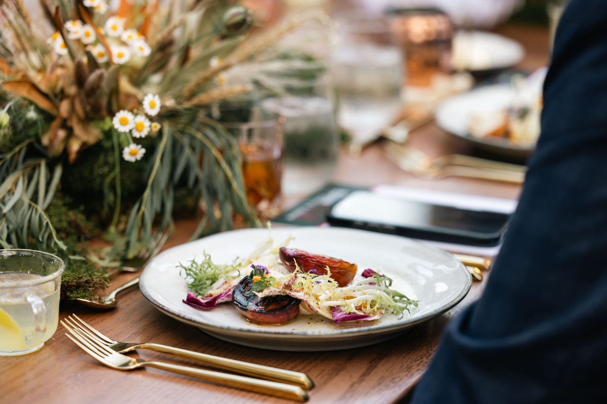 A person sitting in front of a plate with some food on it ready to eat