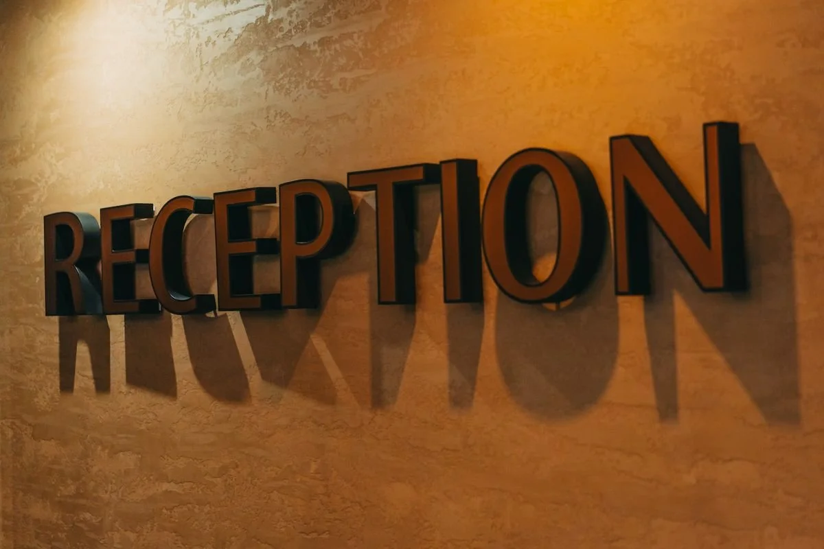 A sign on the wall that says reception