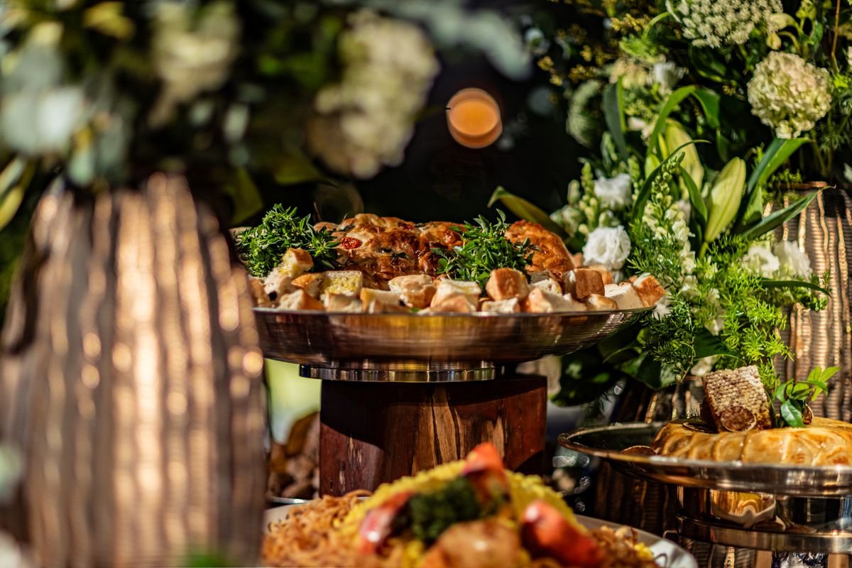 A table with a ton of food all piled onto it