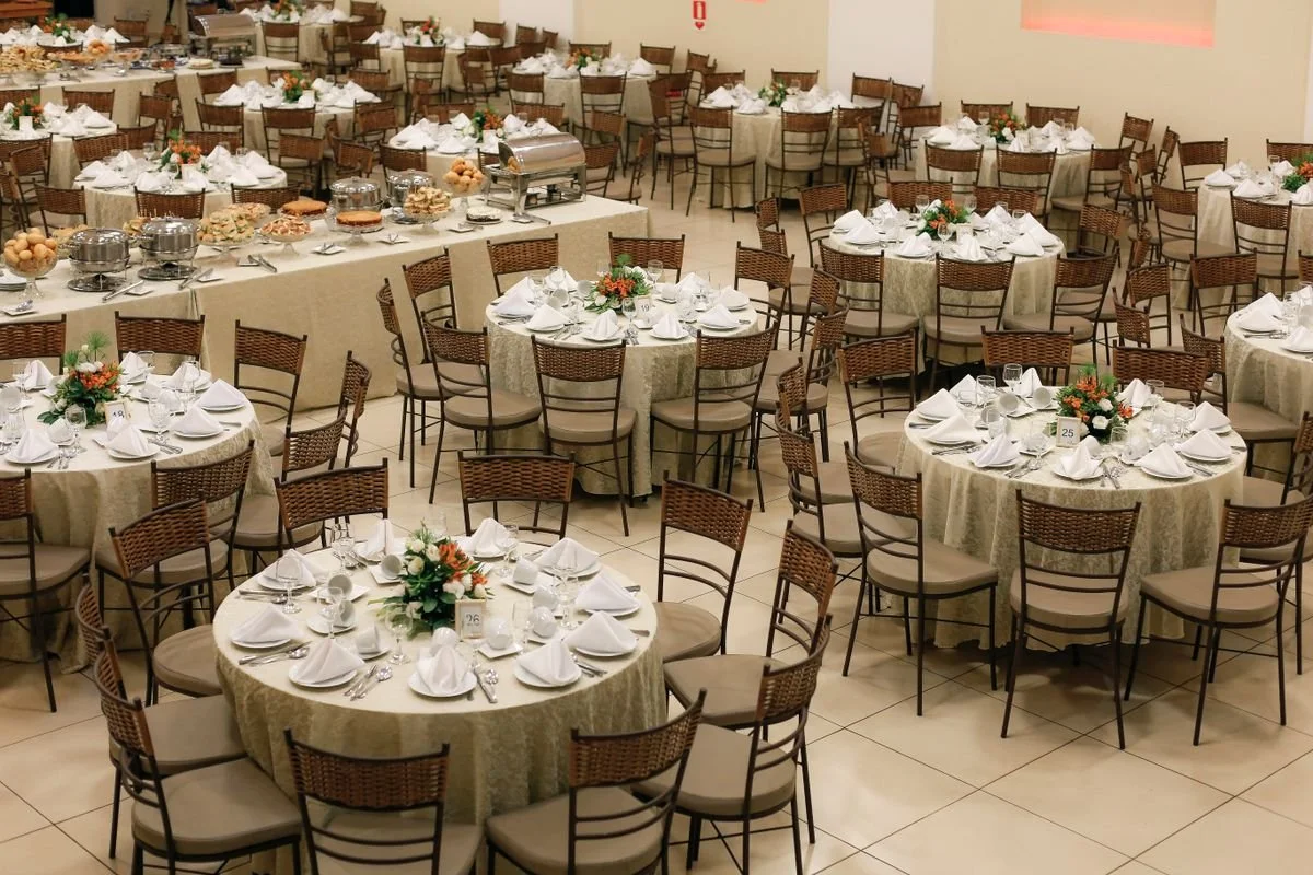 A bunch of tables and chairs set up for a catering event