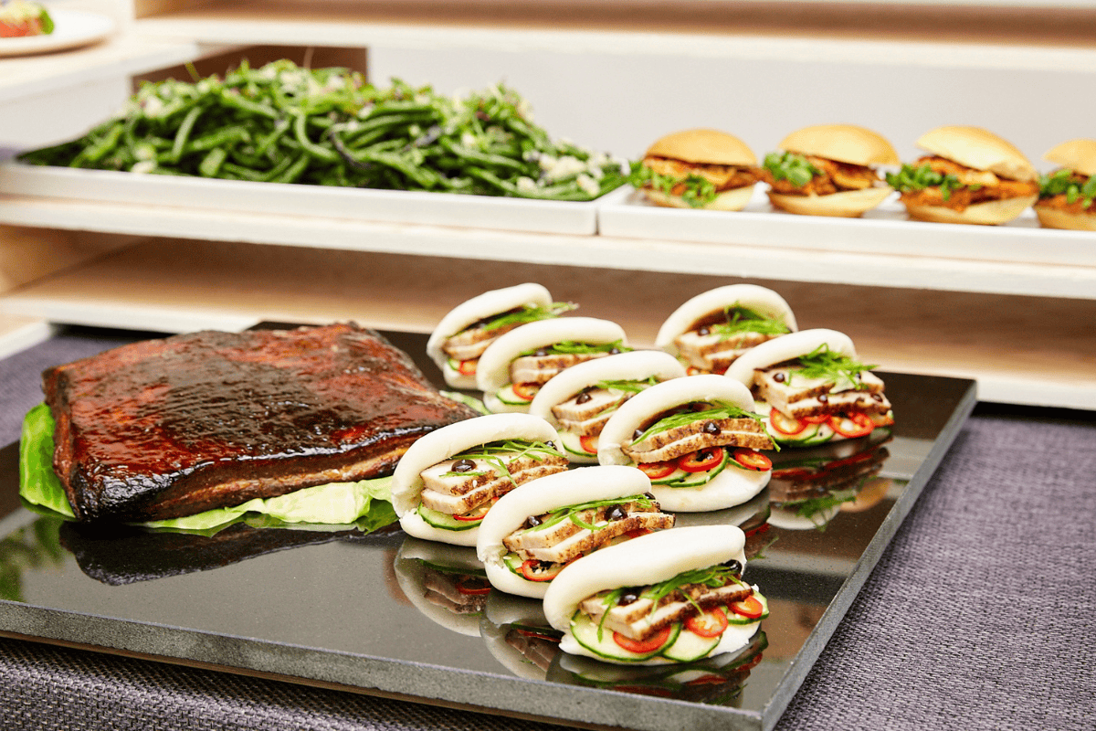 A platter of meat and sandwiches on a table