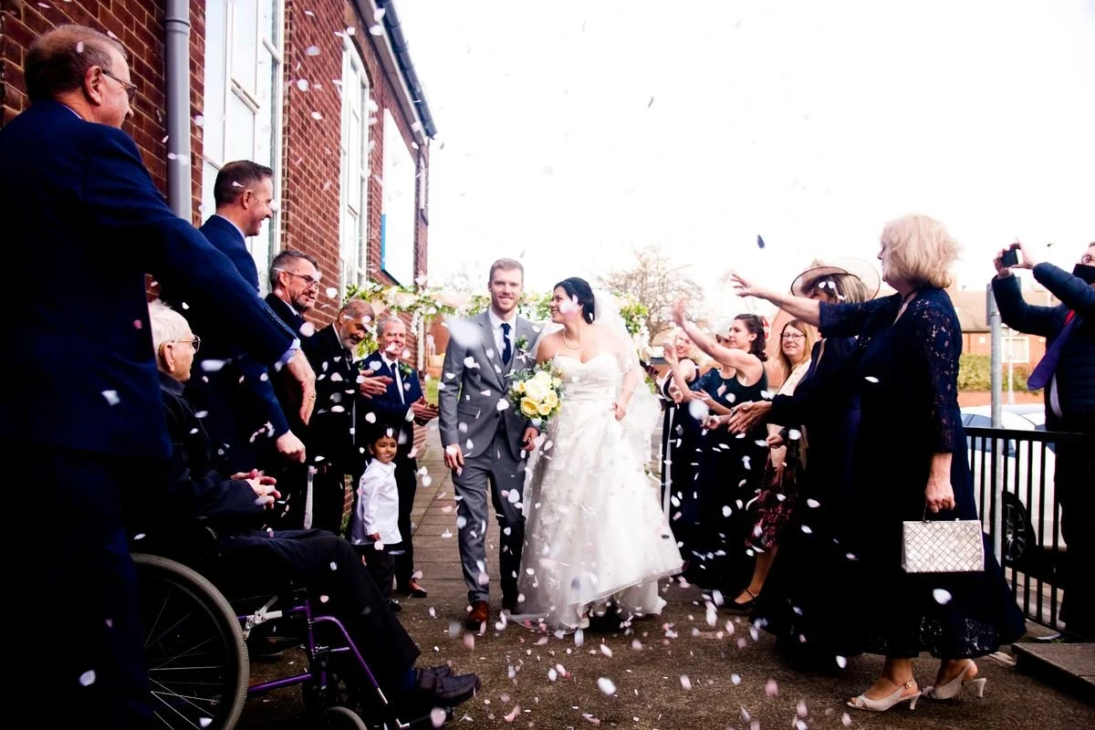 A wedding party sending the bride and groom off