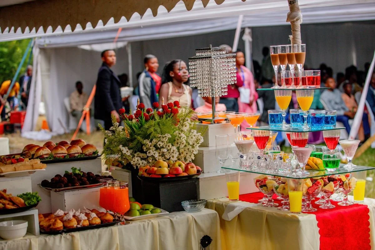 A wedding event with a bunch of food and drinks stacked on a table