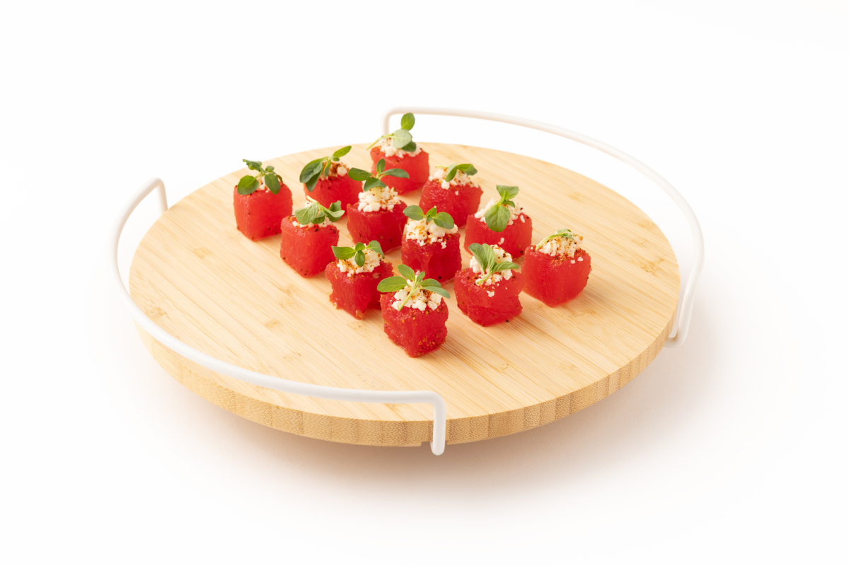 A bunch of little watermelon on a wooden platter