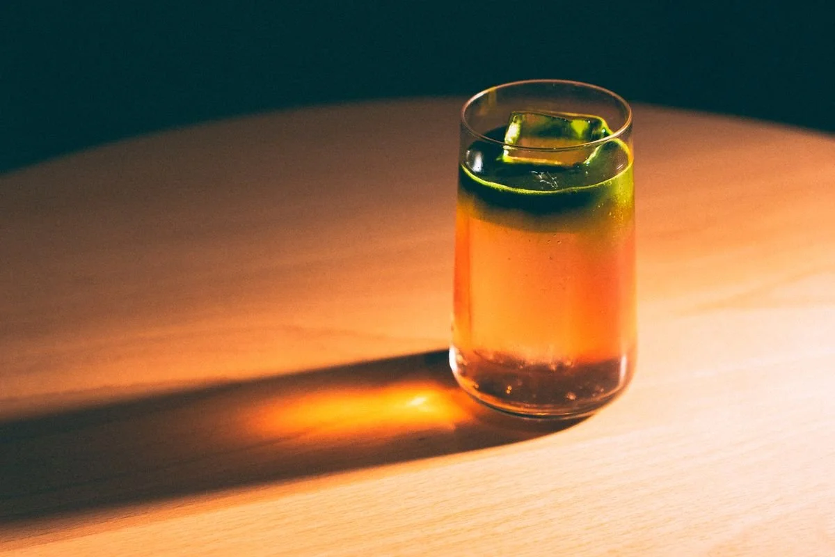 A single cocktail glass on a wooden table