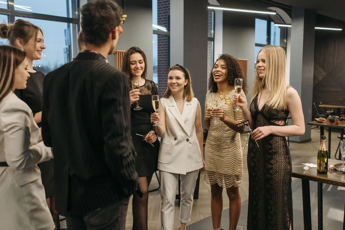 A bunch of people having a party and are all dressed up