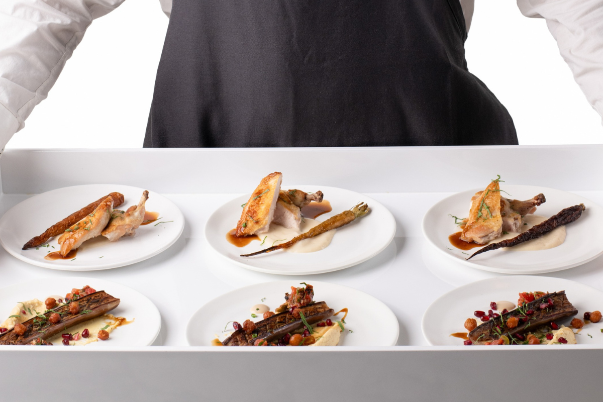 A person holding a platter of food