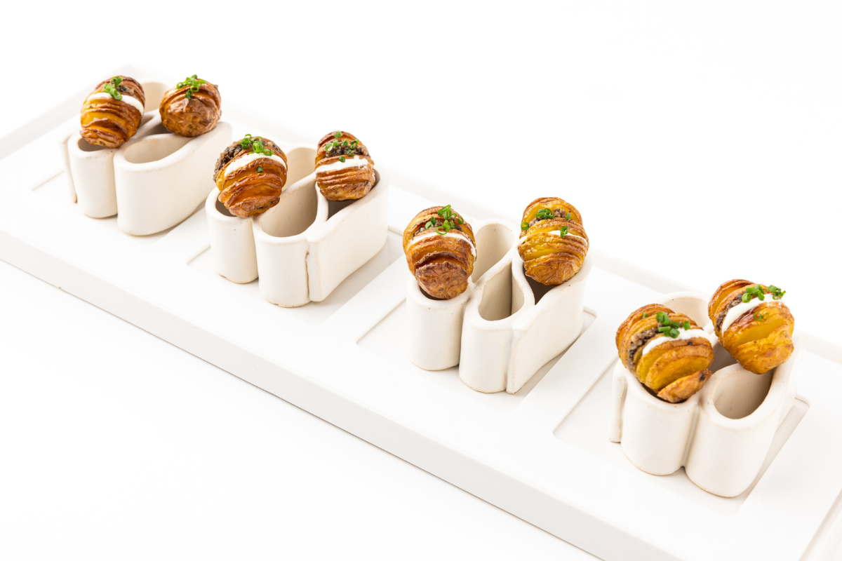 A bunch of croissants sitting in a bunch of porcelain holders
