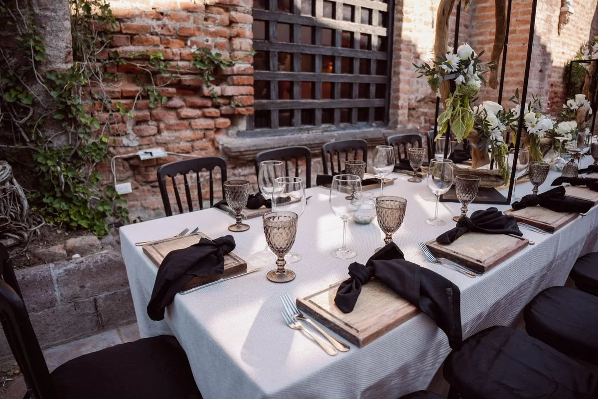 A venue with a table and chairs next to a brick wall