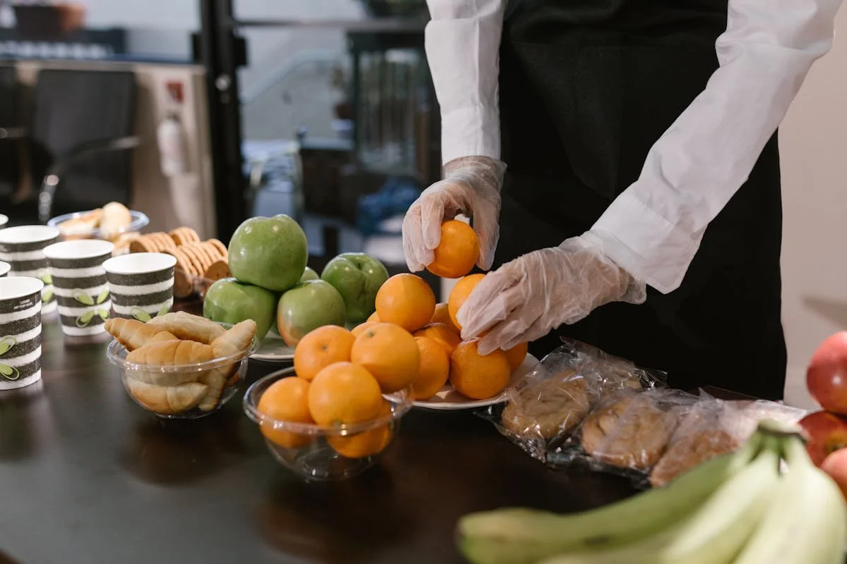 A server putting oranges on a plate