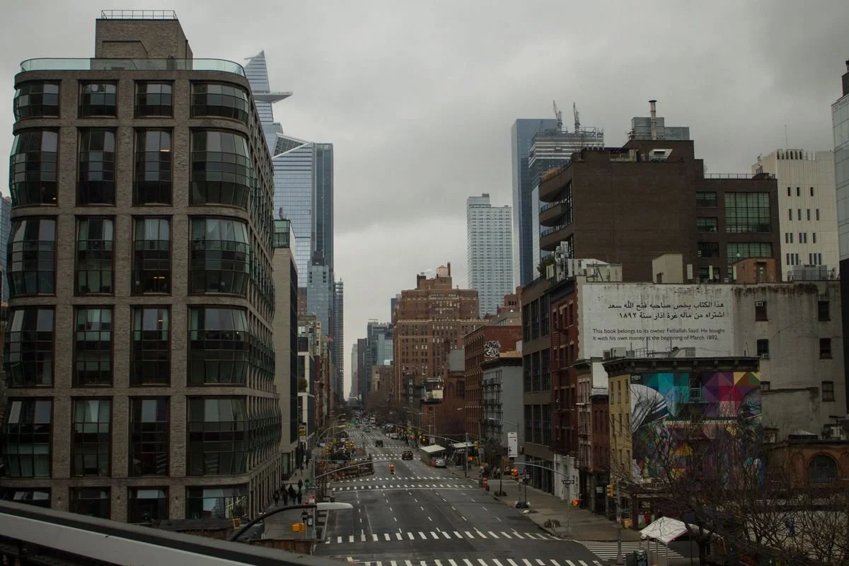 A view of the road in Manhattan with a few cars