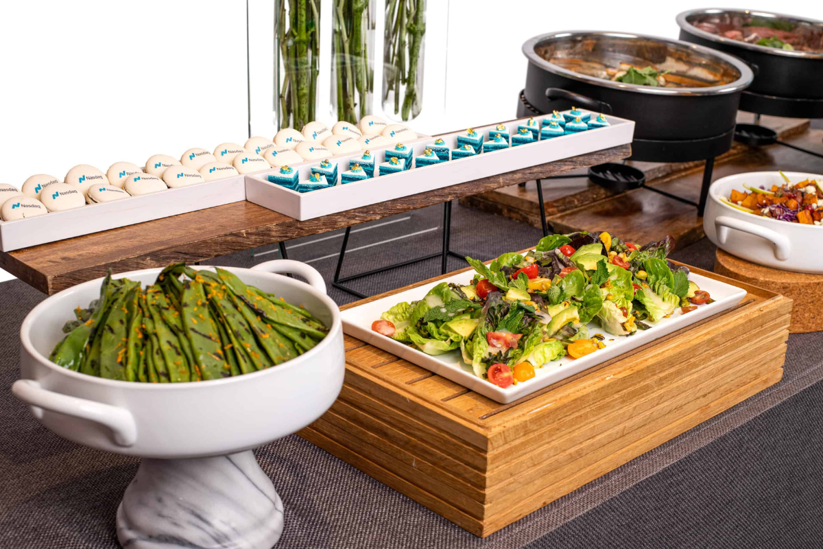 A table with a bunch of food platters on it for a catering event