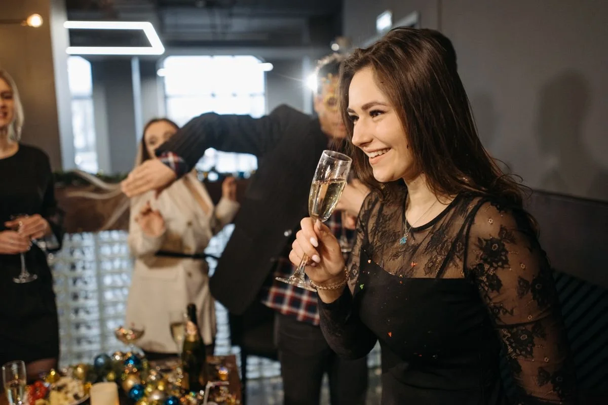 People at a holiday party drinking out of glasses