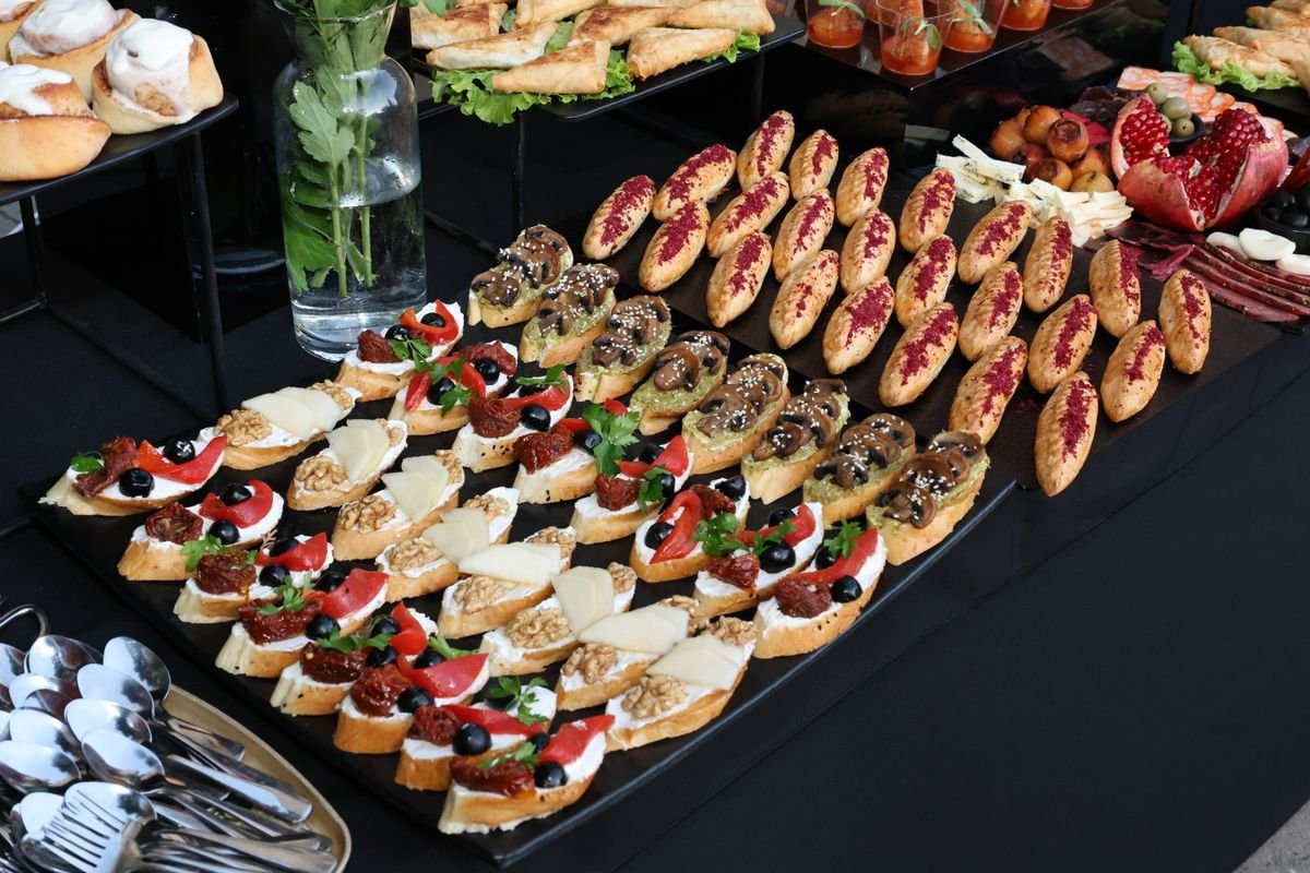 A table covered in all sorts of pastries and food for a catering event
