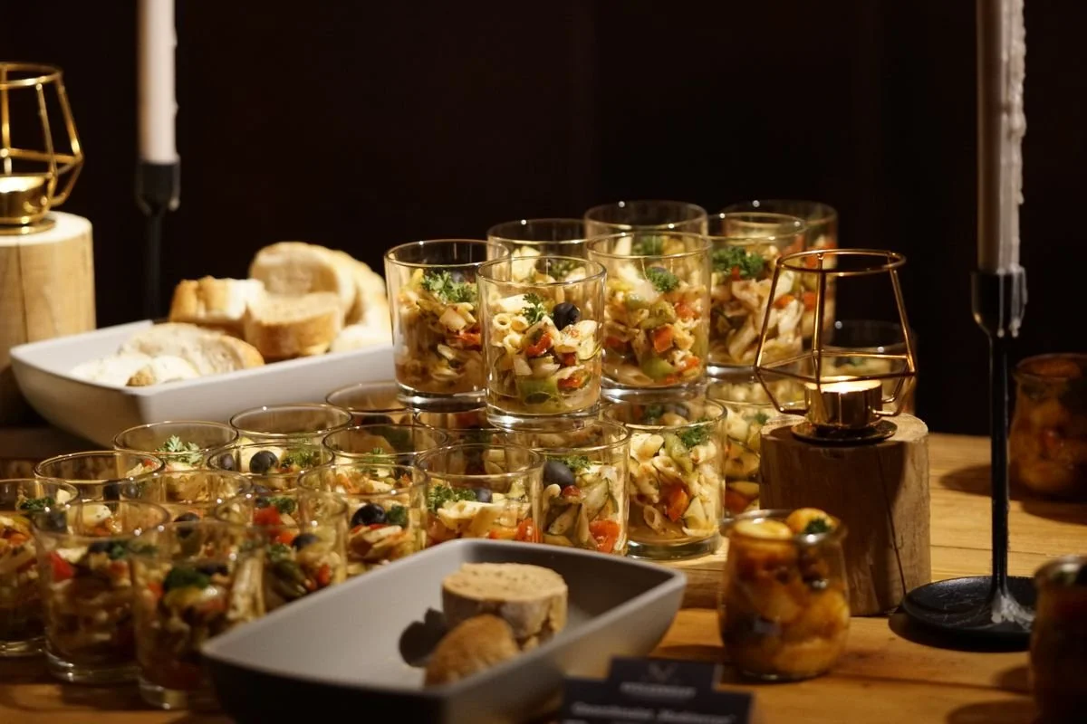 A bunch of glasses with food in them for a catering event