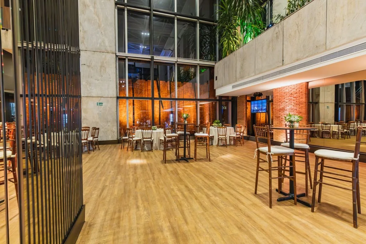 A room with tables and chairs next to some windows