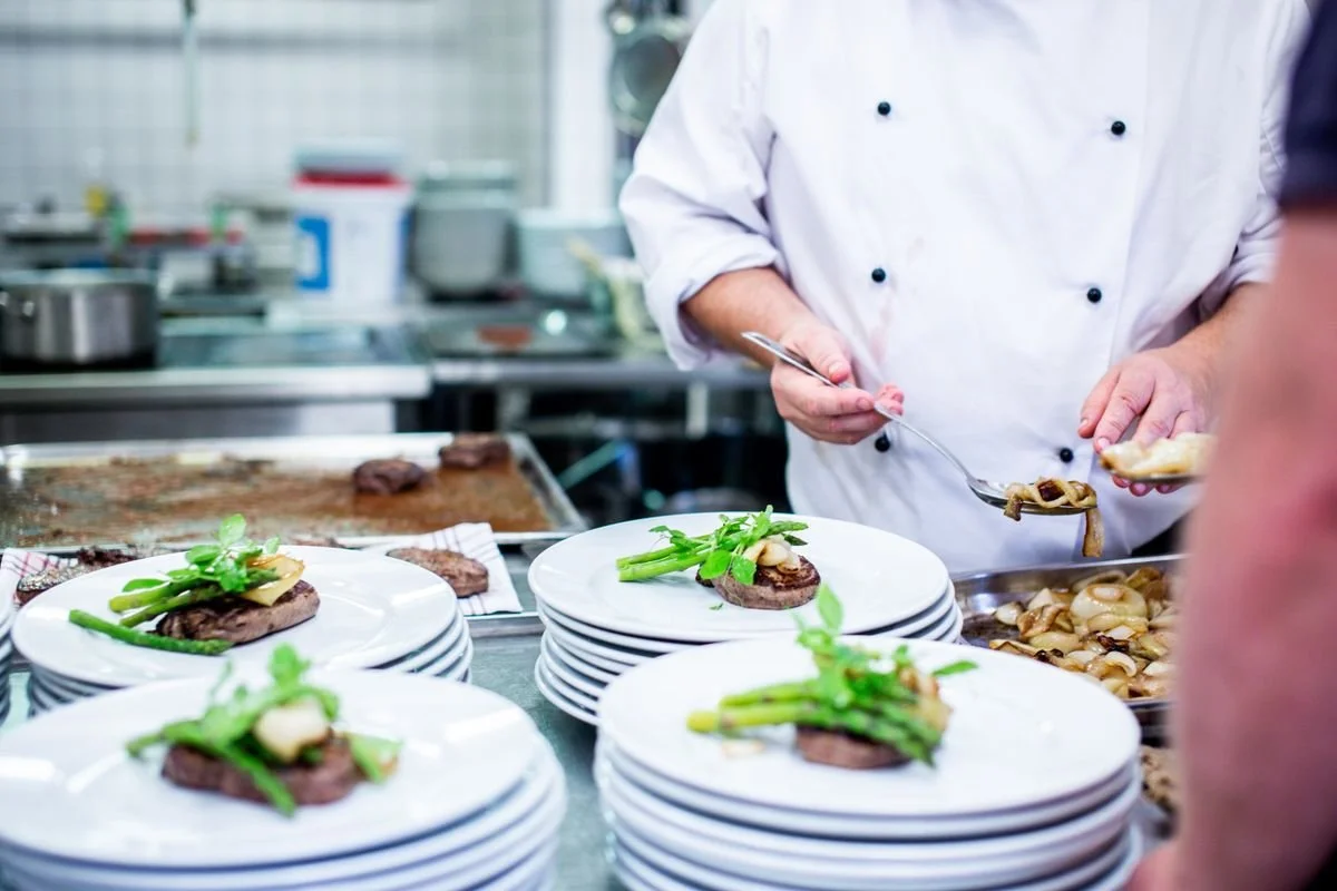 A chef making plates of food for catering