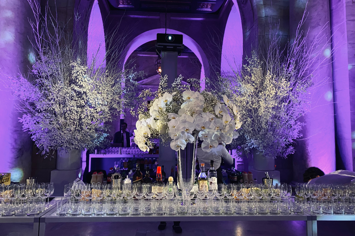 A venue with a bunch of tables with glasses on them