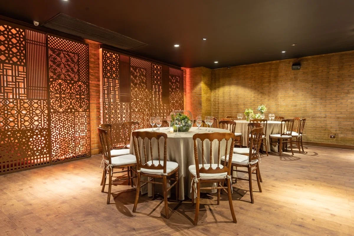 A couple tables ready for people at a catered event