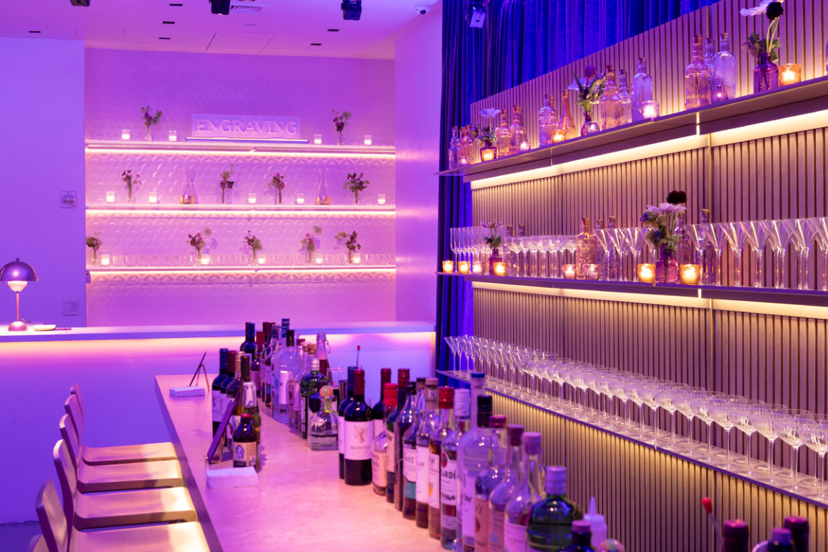 A bar with a bunch of alcohol bottles on it