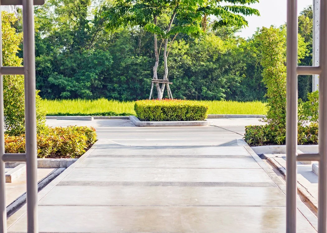 Concrete sidewalk leading out to a commercial parking lot in Columbus, Ohio.
