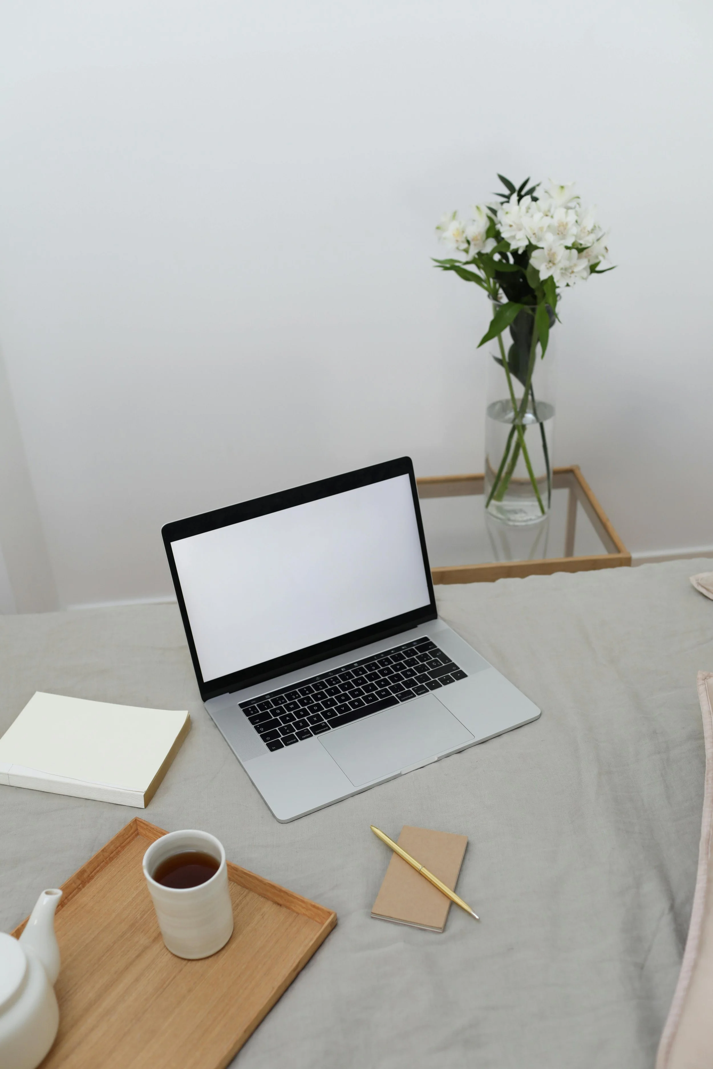 open laptop on desk in white and biege office