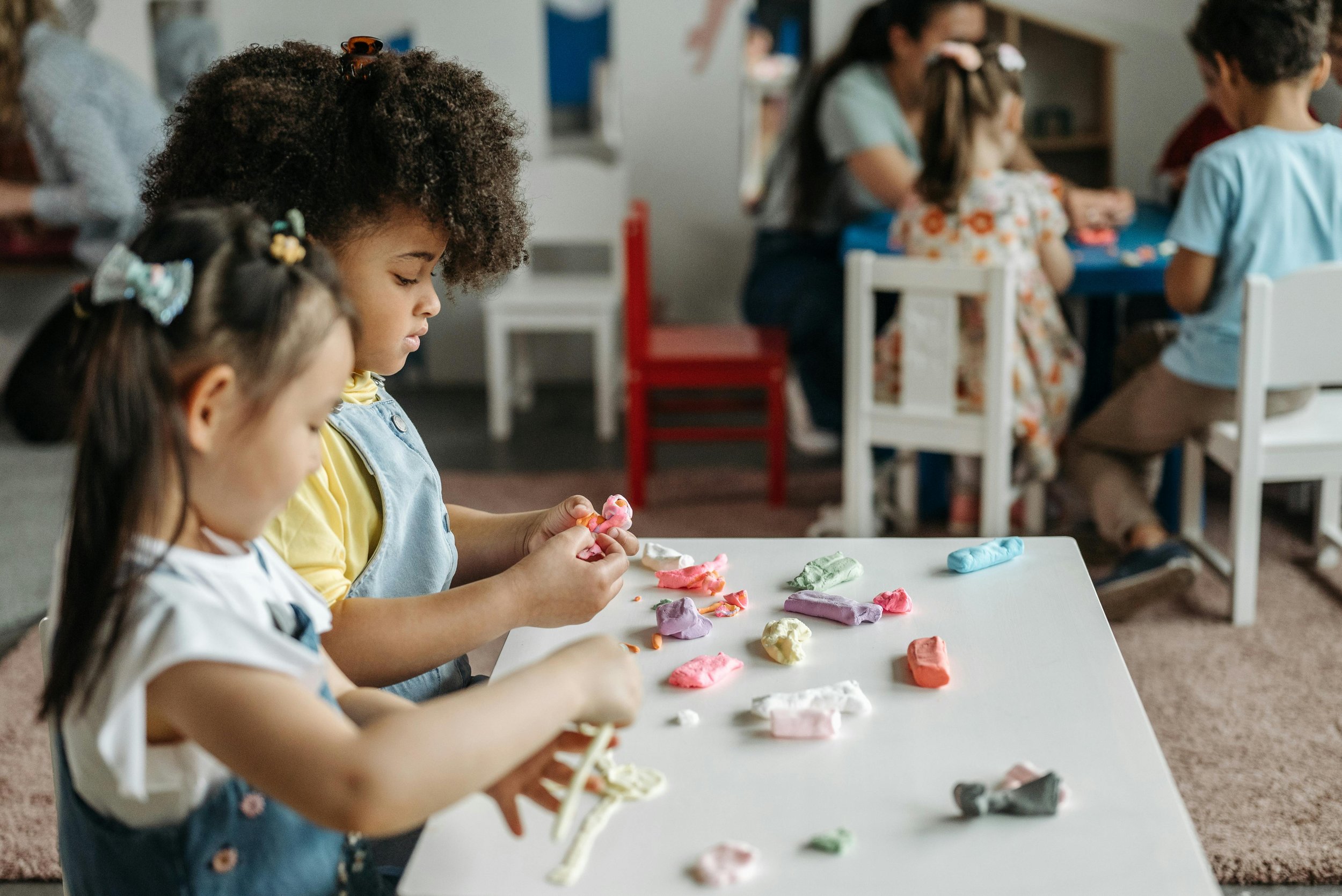 children playing with montessori toys at a table at daycare