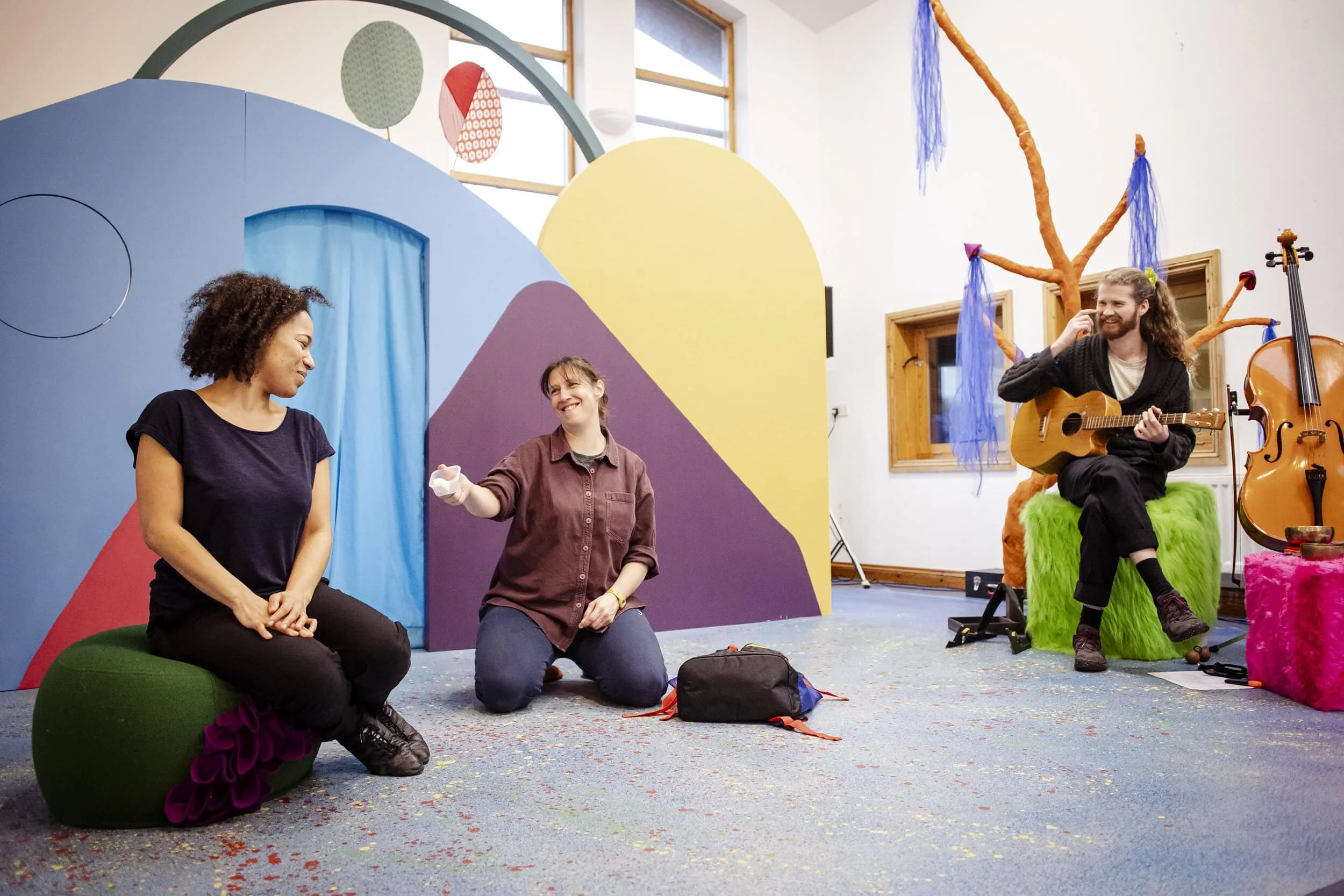  Remi’s looks through a blue curtain during The Forest Door rehearsals. You can only see her head. 