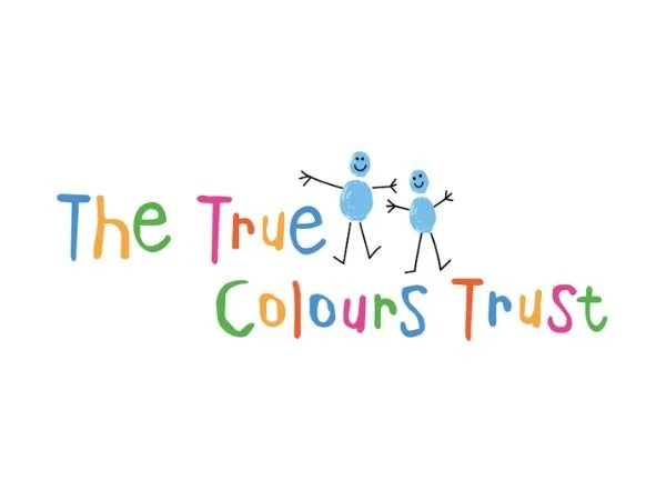 The True Colours Trust logo written in multicoloured writing with stick people.