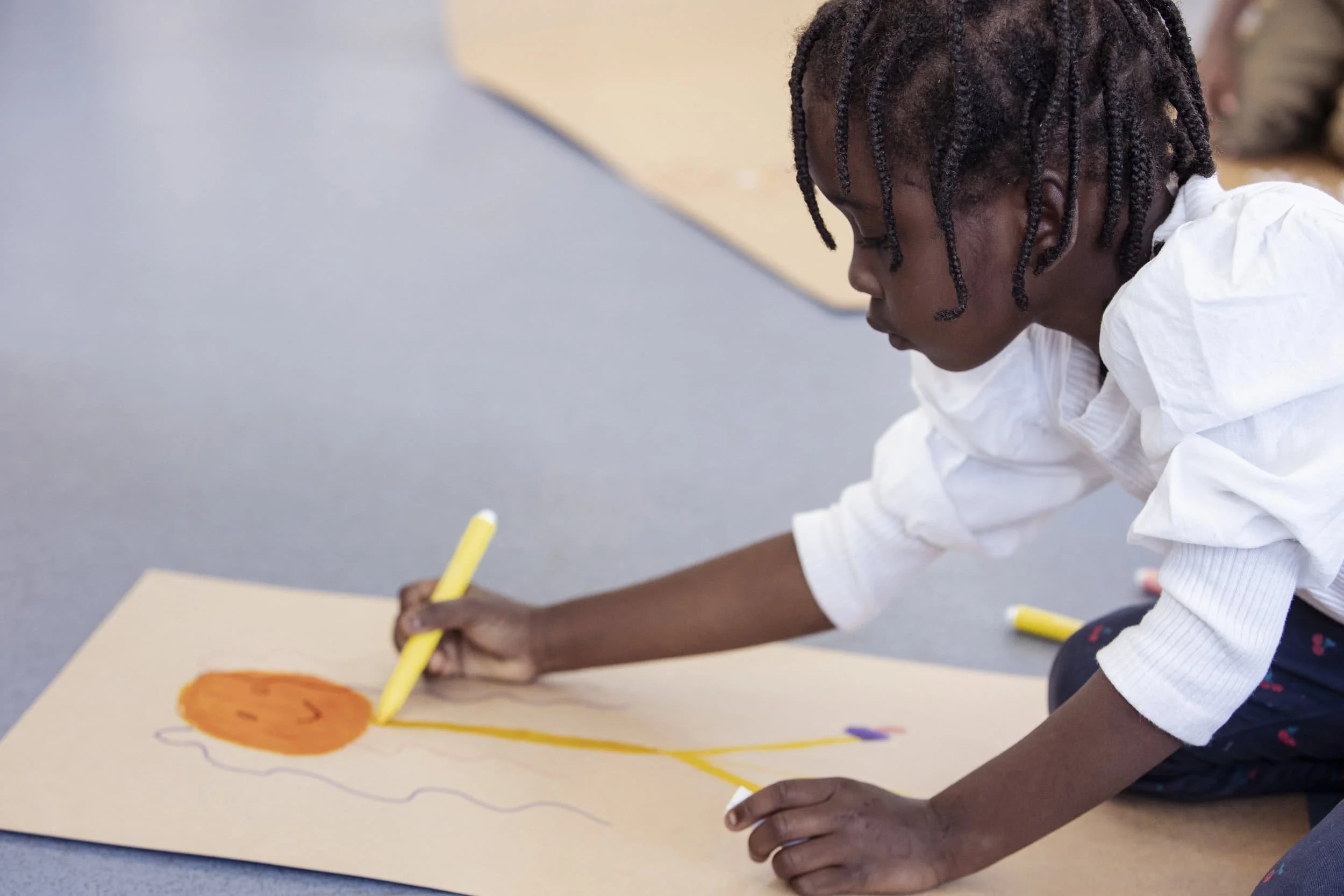 Disabled children sitting in a circle with Travelling Light facillitator