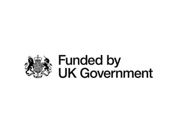 Black writing that reads 'Funded by UK Government' with the government emblem to the left of the writing.
