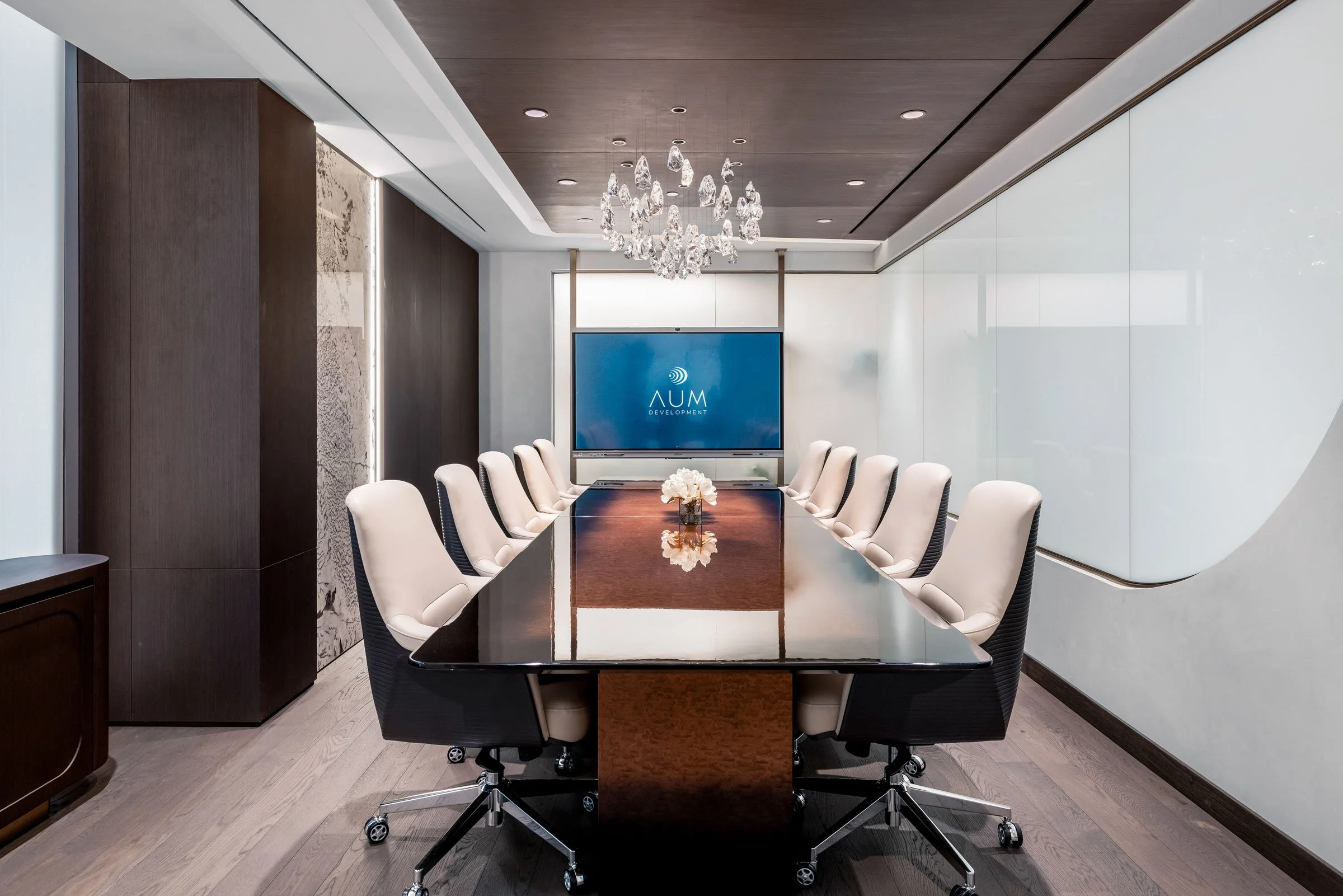 Corporate boardroom photography featuring premium furniture, reflective finishes, statement chandelier and modern workplace design.