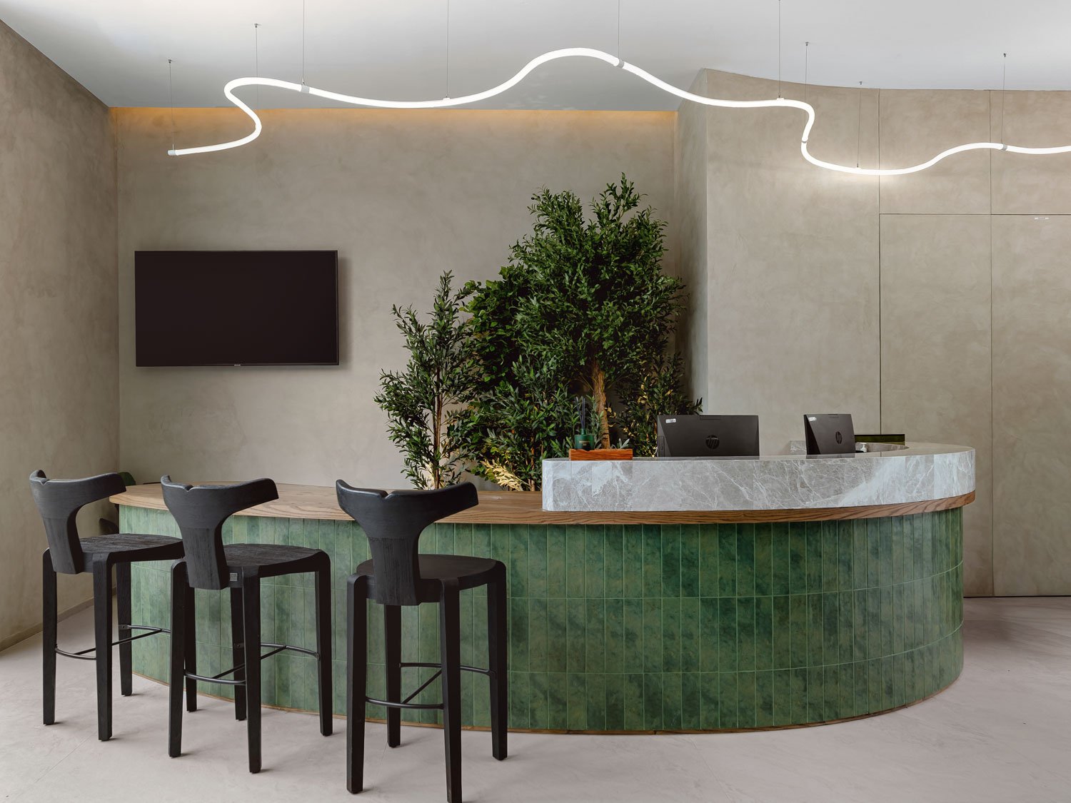 Commercial interior photography showcasing a contemporary reception area with bespoke finishes, modern lighting, and premium workplace design in Dubai.
