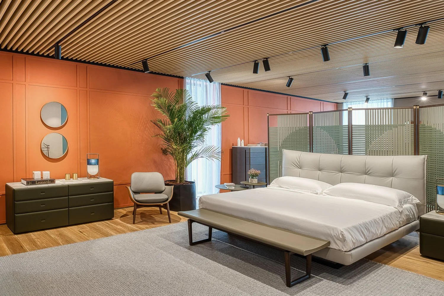 Interior photography of a luxury furniture showroom featuring contemporary bedroom styling, premium materials, and architectural lighting.