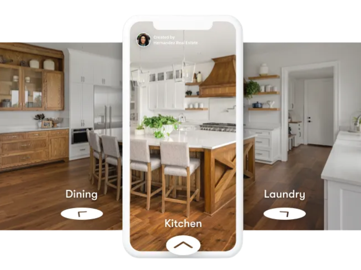 Photo of a modern kitchen with white cabinets, a wooden range hood, and a kitchen island with beige bar stools, displayed on a smartphone app with access to dining, kitchen, and laundry areas.