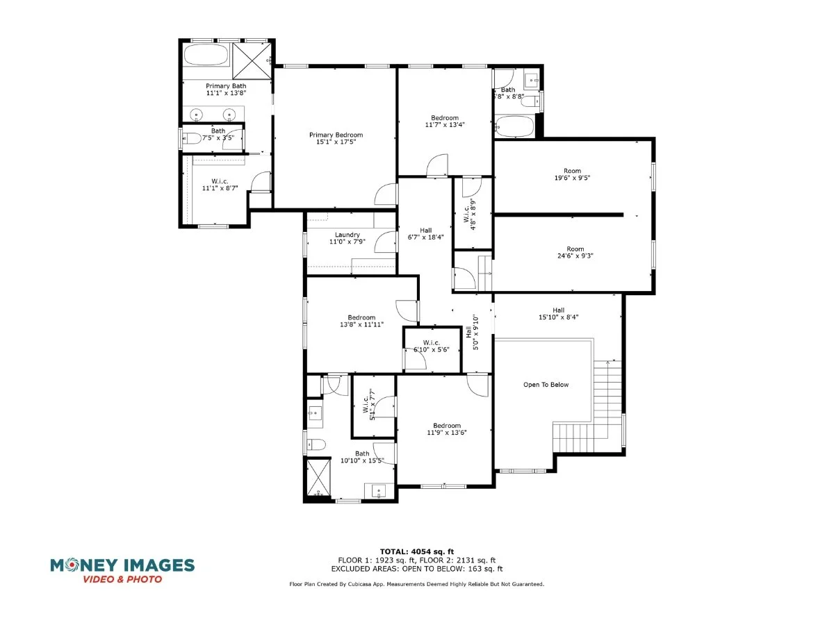 Floor plan of a house with multiple bedrooms, bathrooms, hallways, a laundry room, and open spaces.