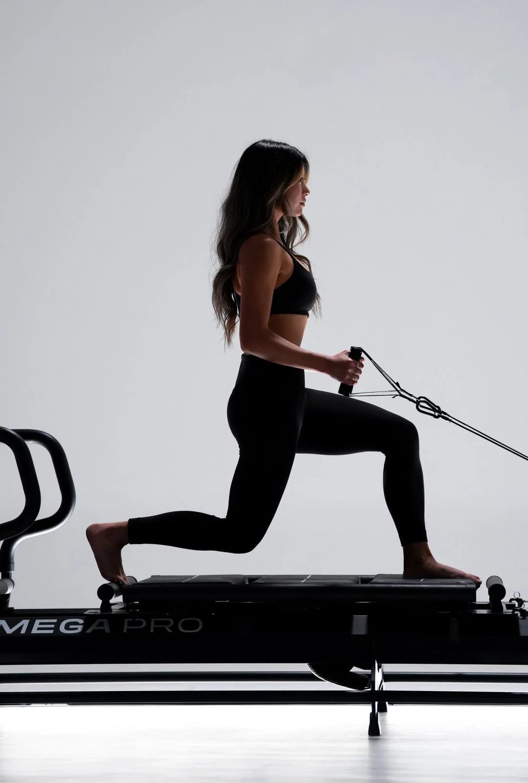 Image of female model working out on a Lagree Fitness Pilates machine