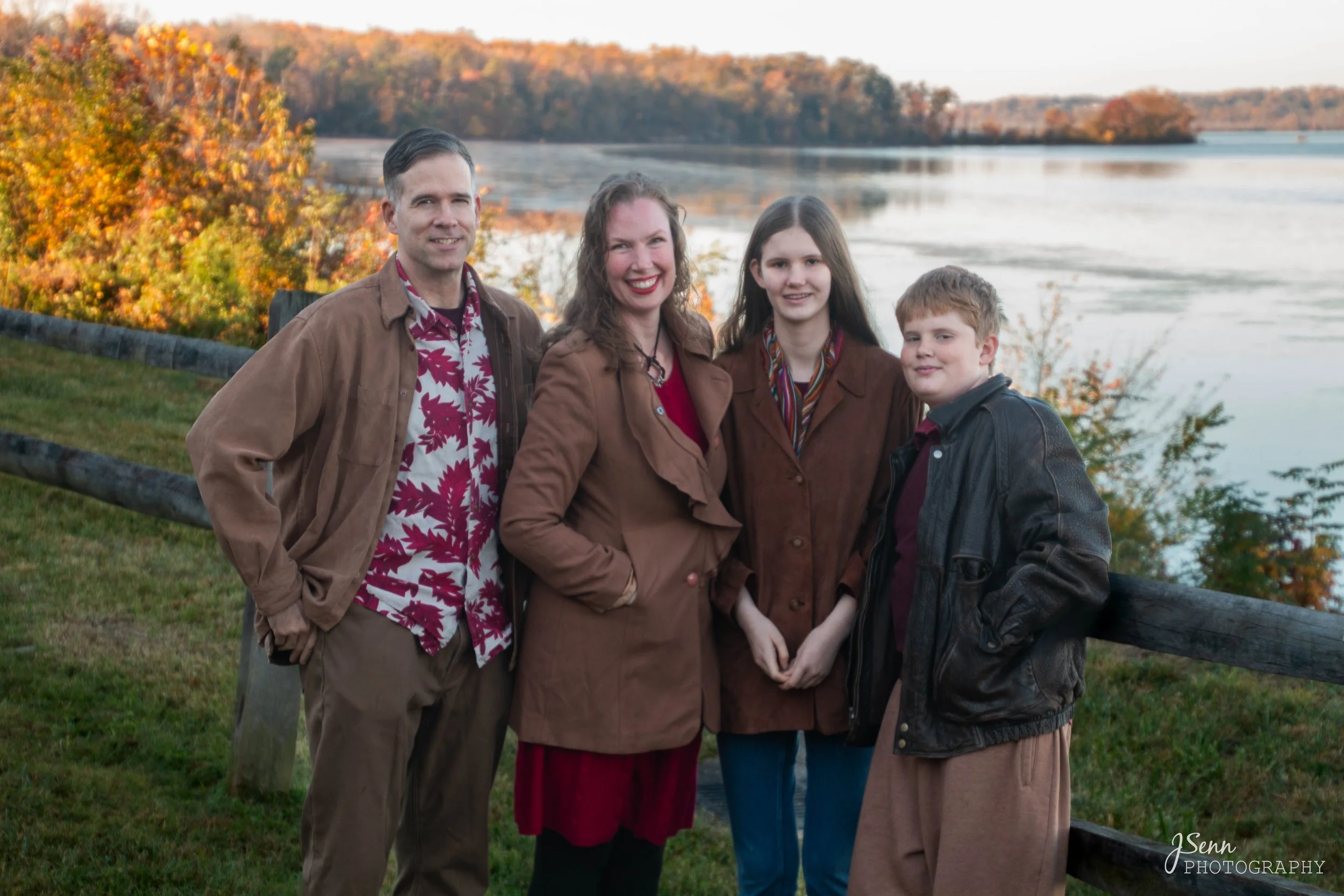Jenn Scott, pediatric speech-language pathologist at Play to Say Therapy, with her family in an autumn outdoor portrait near the water in Northern Virginia