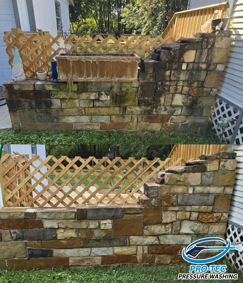 Comparison of a stone wall before and after pressure washing, showing cleaner and brighter stones in the after image, with a wooden fence in the background.