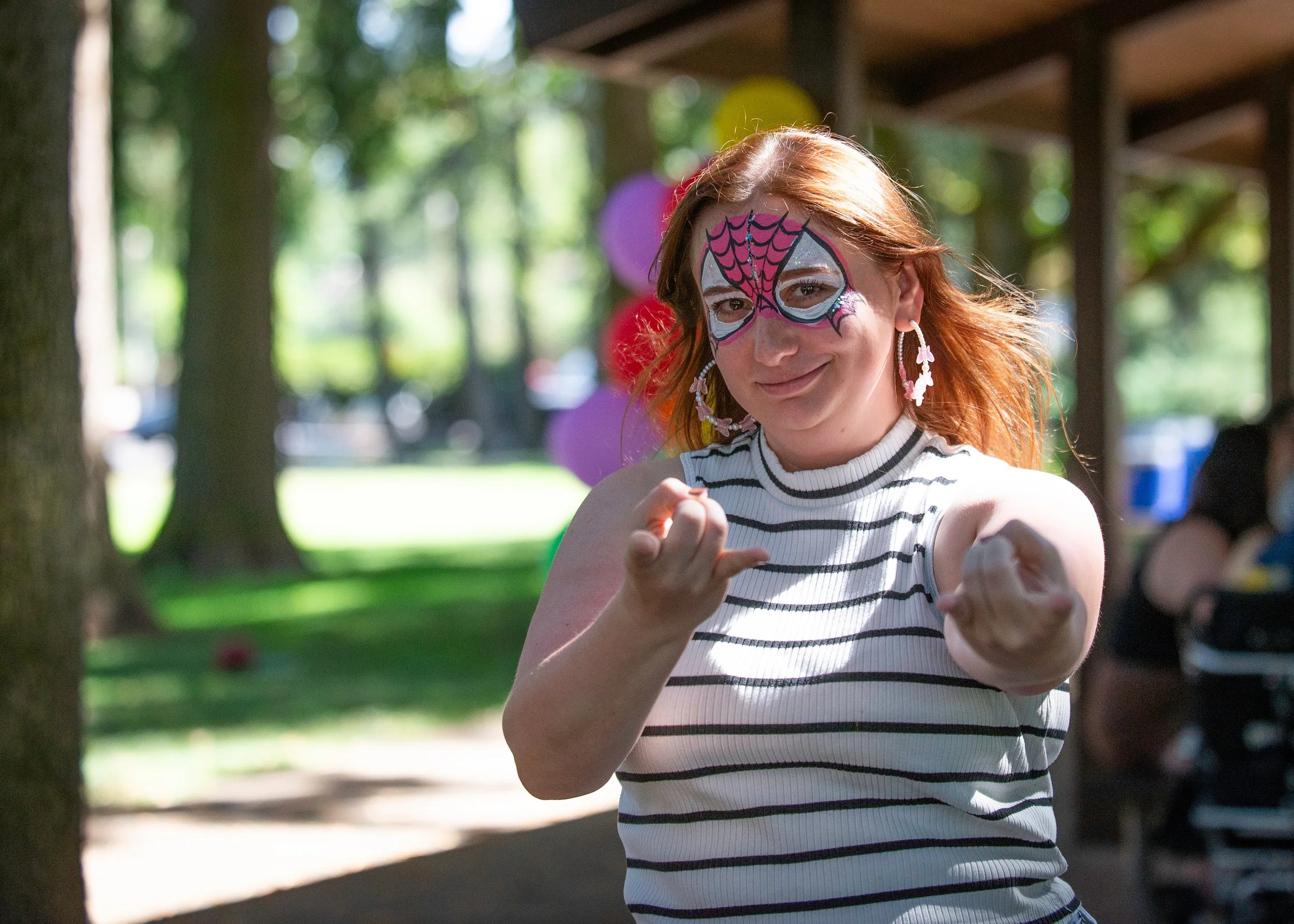 A young woman attending a Corporate Event with Spider-Man face painting in Eugene, Oregon.
