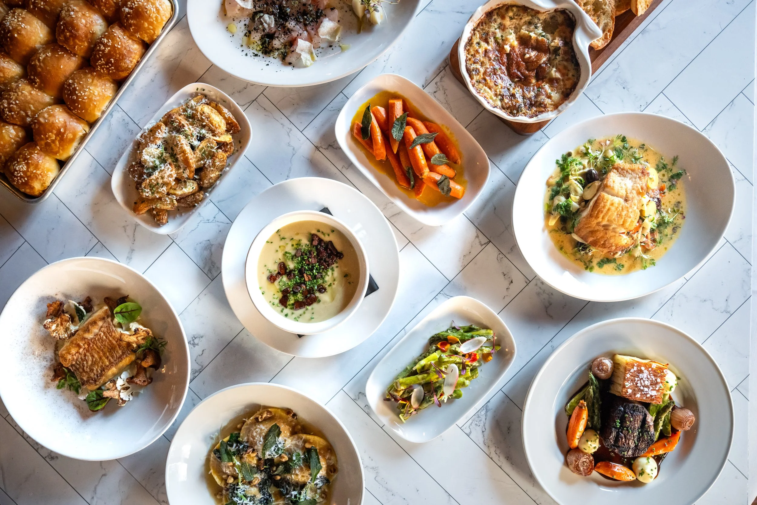 A tasting menu of Circa 1922 dishes including small plates, salads, entrees, and fresh baked rolls.