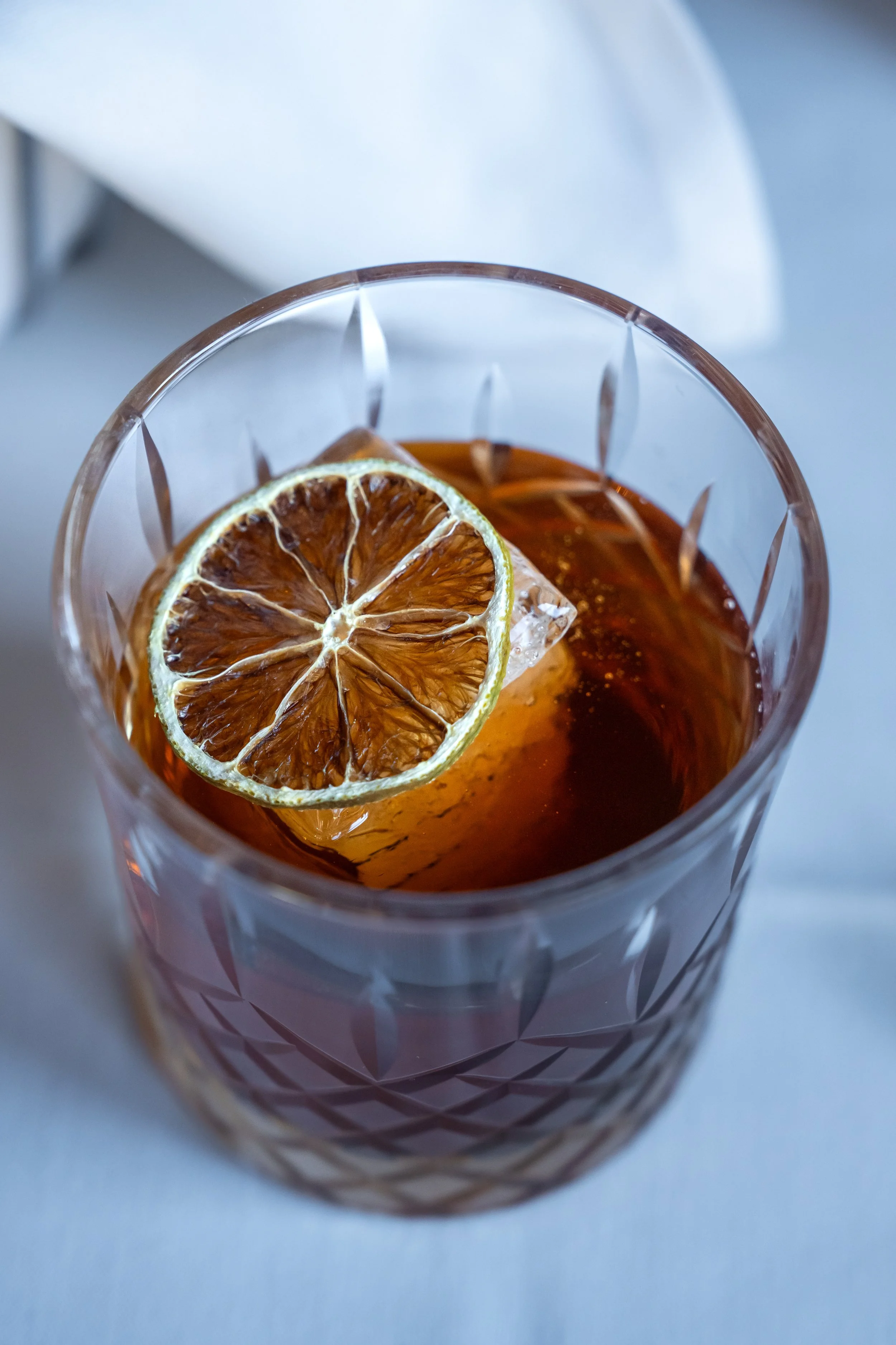 Barrel-Aged Old Fashioned made with Old Forester 100 Proof, Demerara Sugar, Regan's Orange Bitters, Burnt Orange.