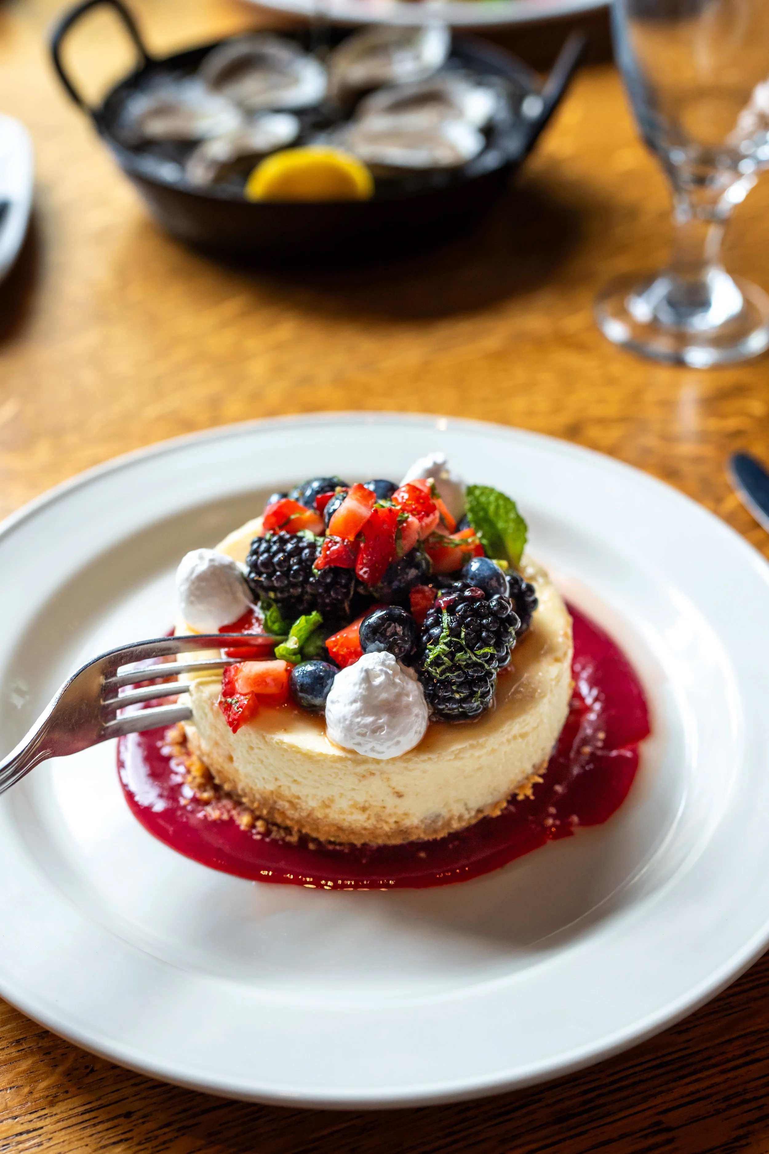 Classic New York Cheesecake served with Mixed Berries, Strawberry Coulis.