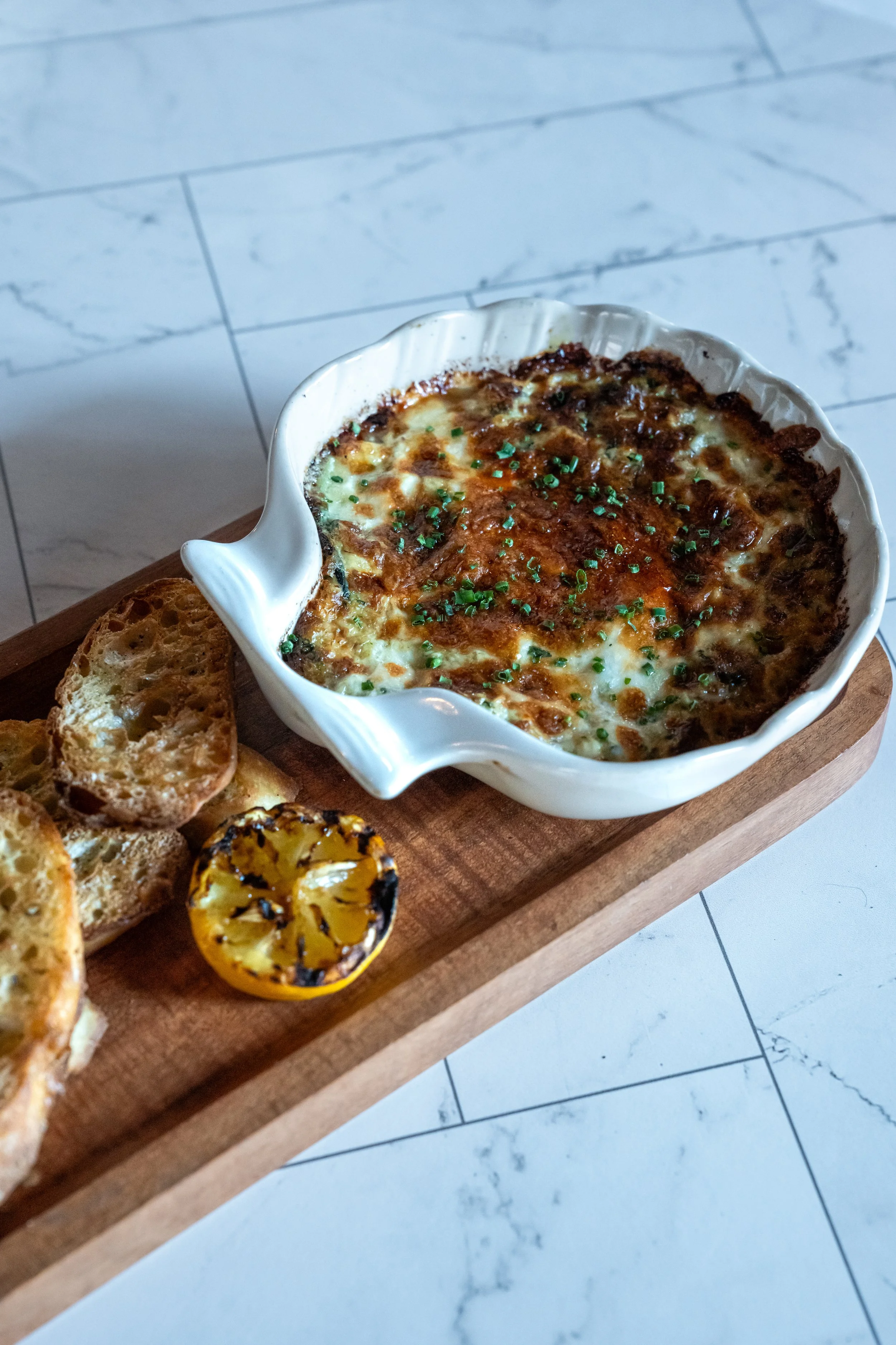 Circa 1922's famous Crab Dip made with Artichokes, Spinach, and White Cheddar and served with homemade Crostini