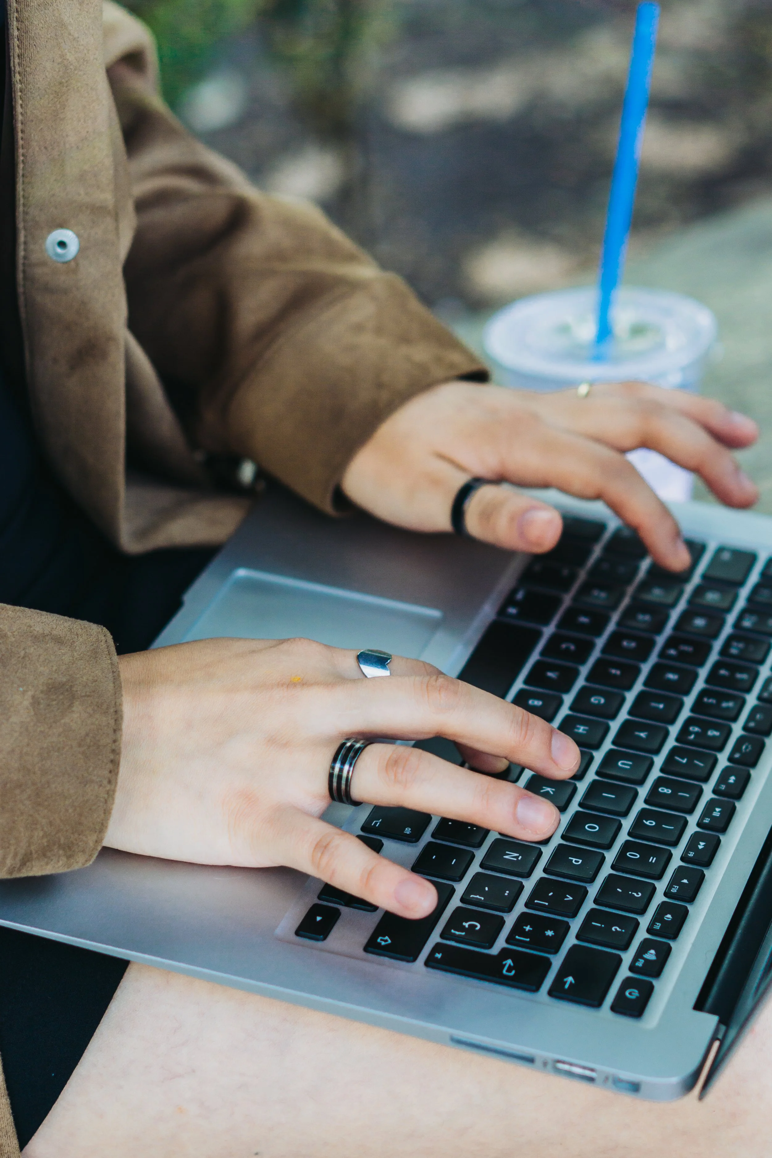Woman typing on a laptop outdoors