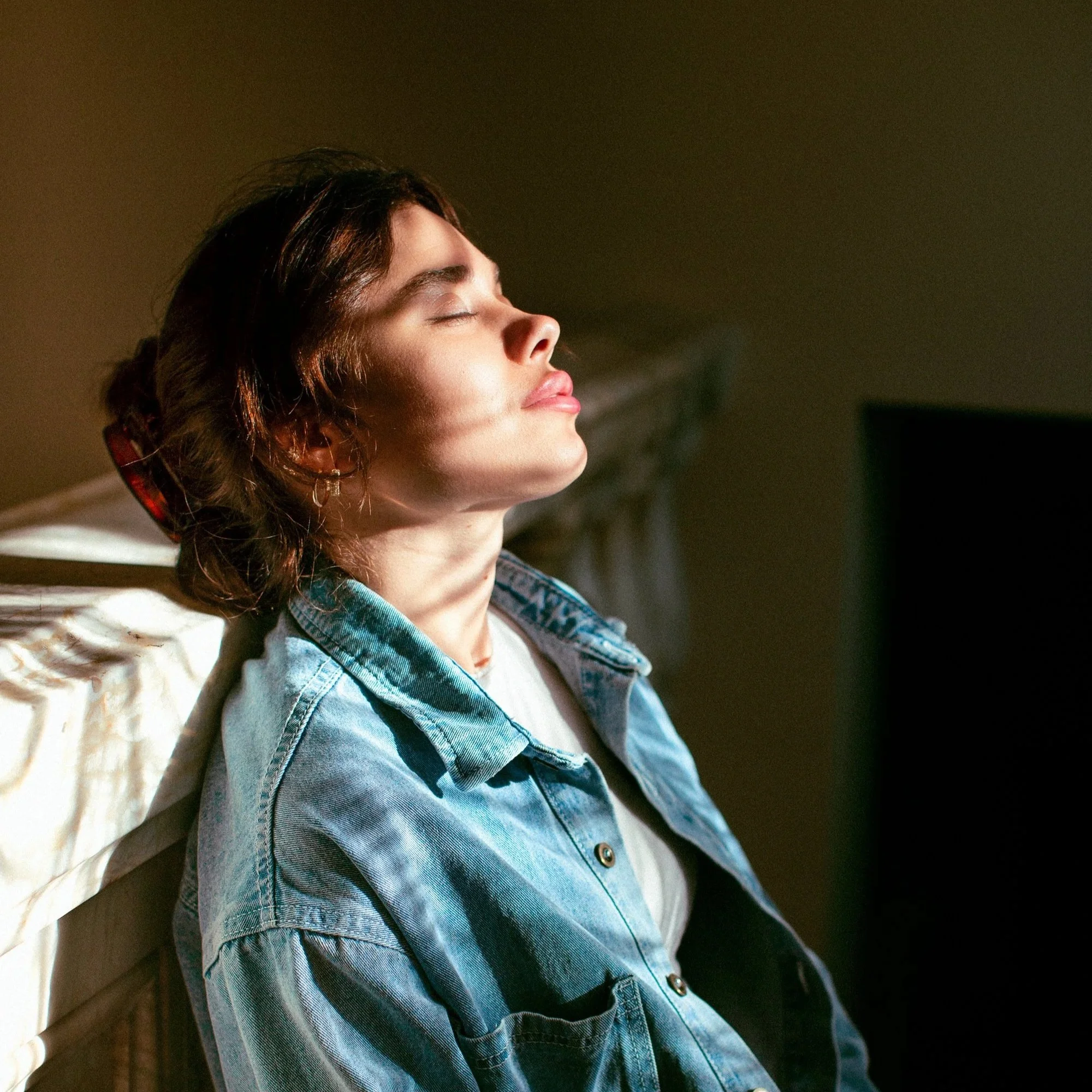 Woman standing indoors in a relaxed pose