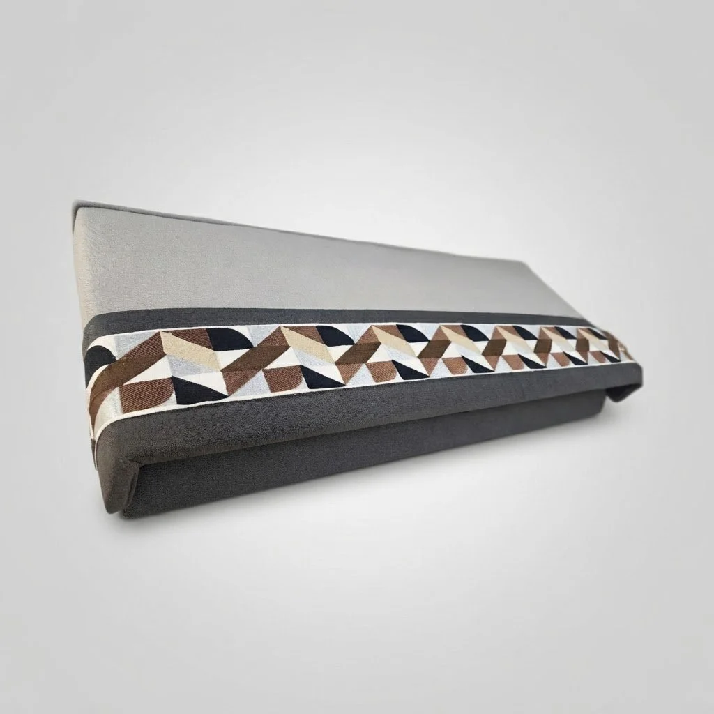Custom-tailored upholstered valance featuring a striking geometric accent band, designed to add a sophisticated top treatment to the
