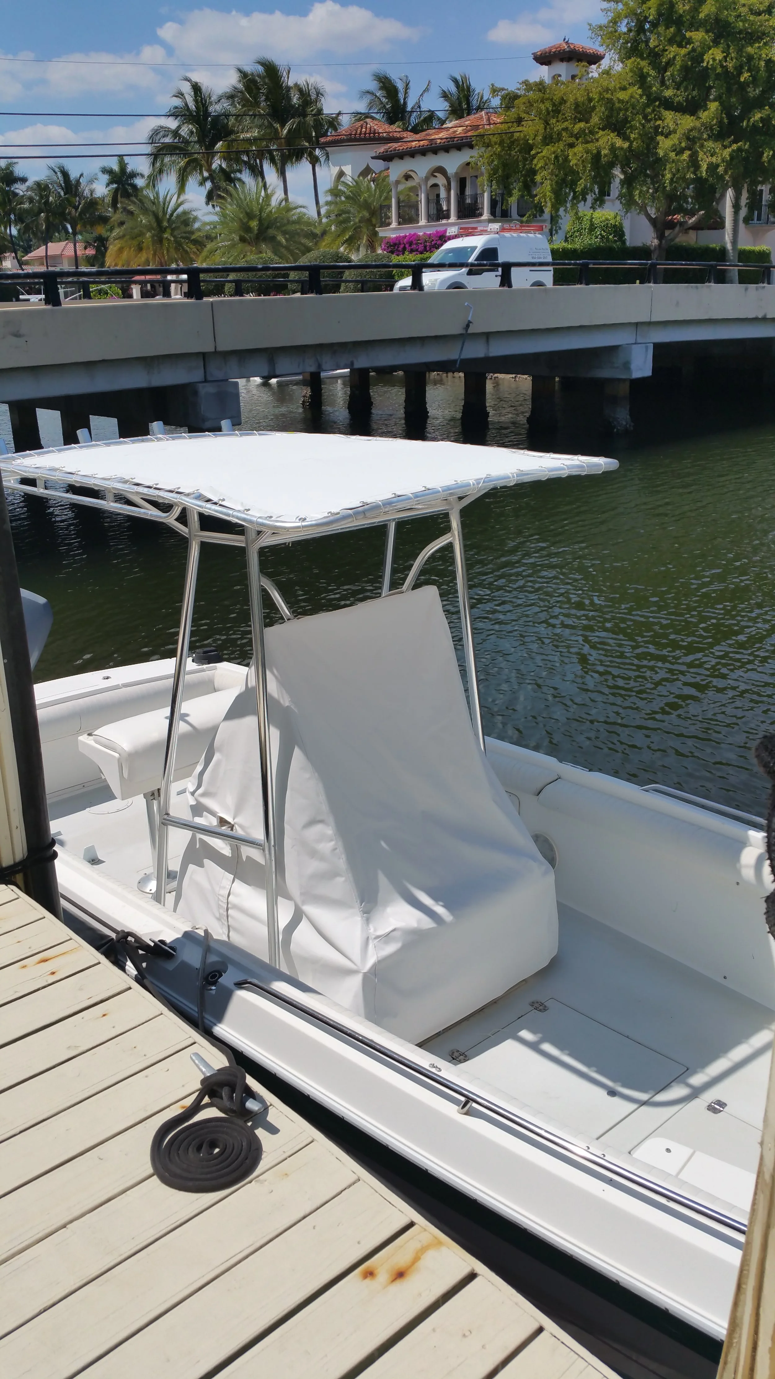 Custom T-top boat bimini cover and helm seat upholstery handcrafted in Fort Lauderdale by London Stitchery.