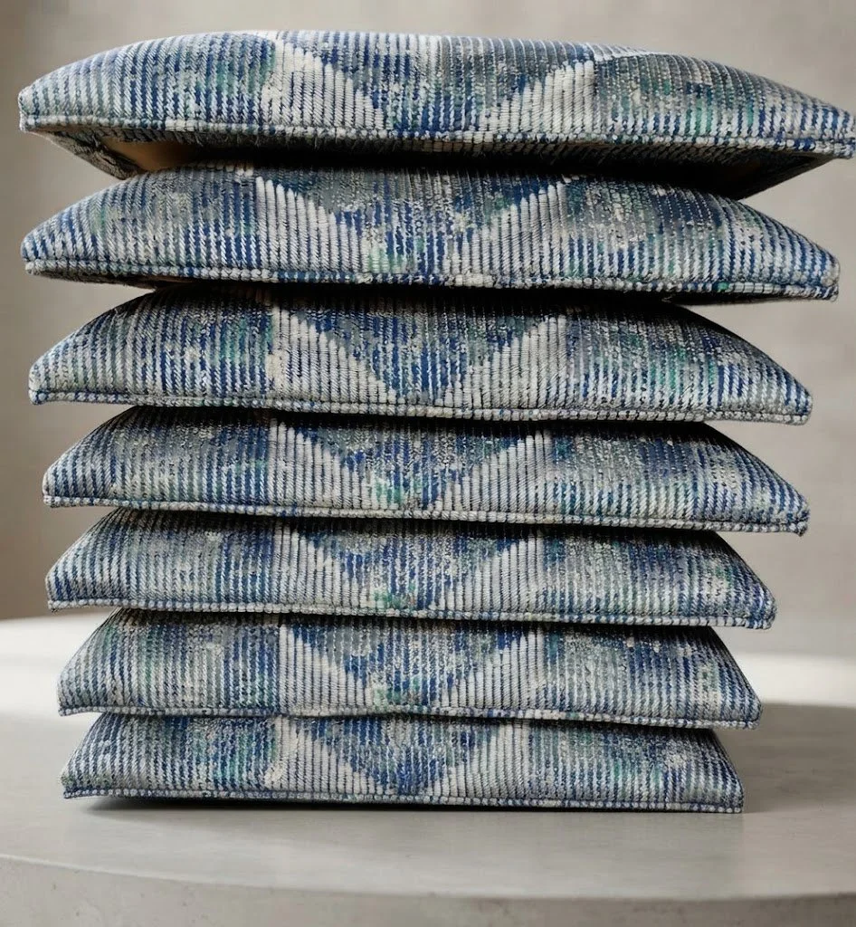 Custom upholstered drop-in seat cushions featuring precise pattern placement and a clean, tailored self-welt finish, crafted by London Stitchery.