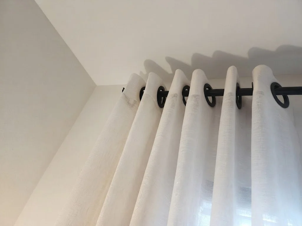 Modern white drapery panels featuring clean grommet headers for a smooth, contemporary glide, custom-crafted by London Stitchery.